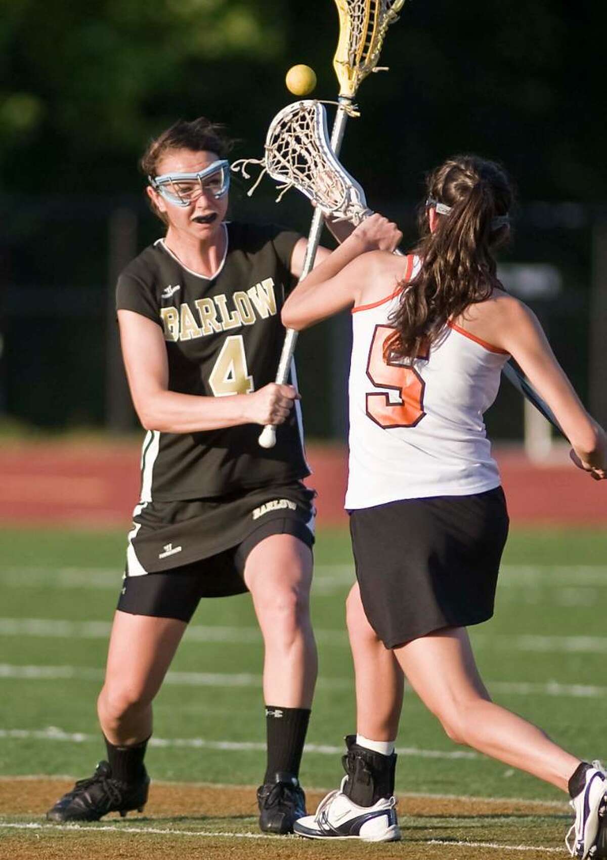 Balow's Libby Barlow tries to get the ball away from Ridgefield's Cara Anne Lockwood during a girls lacrosse game at Ridgefield. Friday, May 14, 2010