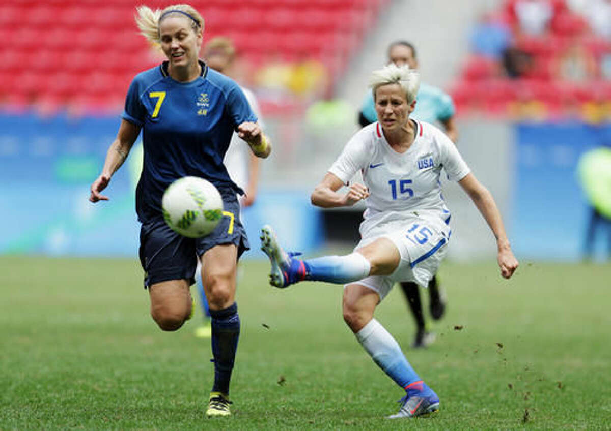 FILE - In this Friday, Aug. 12, 2016, file photo, United States' Megan Rapinoe, right, kicks the ball past Sweden's Lisa Dahlkvist during a quarterfinal match of the women's Olympic soccer tournament in Brasilia. Rapinoe knelt during the national anthem Sunday, Sept. 4, before the Seattle Reign's game against the Chicago Red Stars "in a little nod" to NFL quarterback Colin Kaepernick. (AP Photo/Eraldo Peres, File)