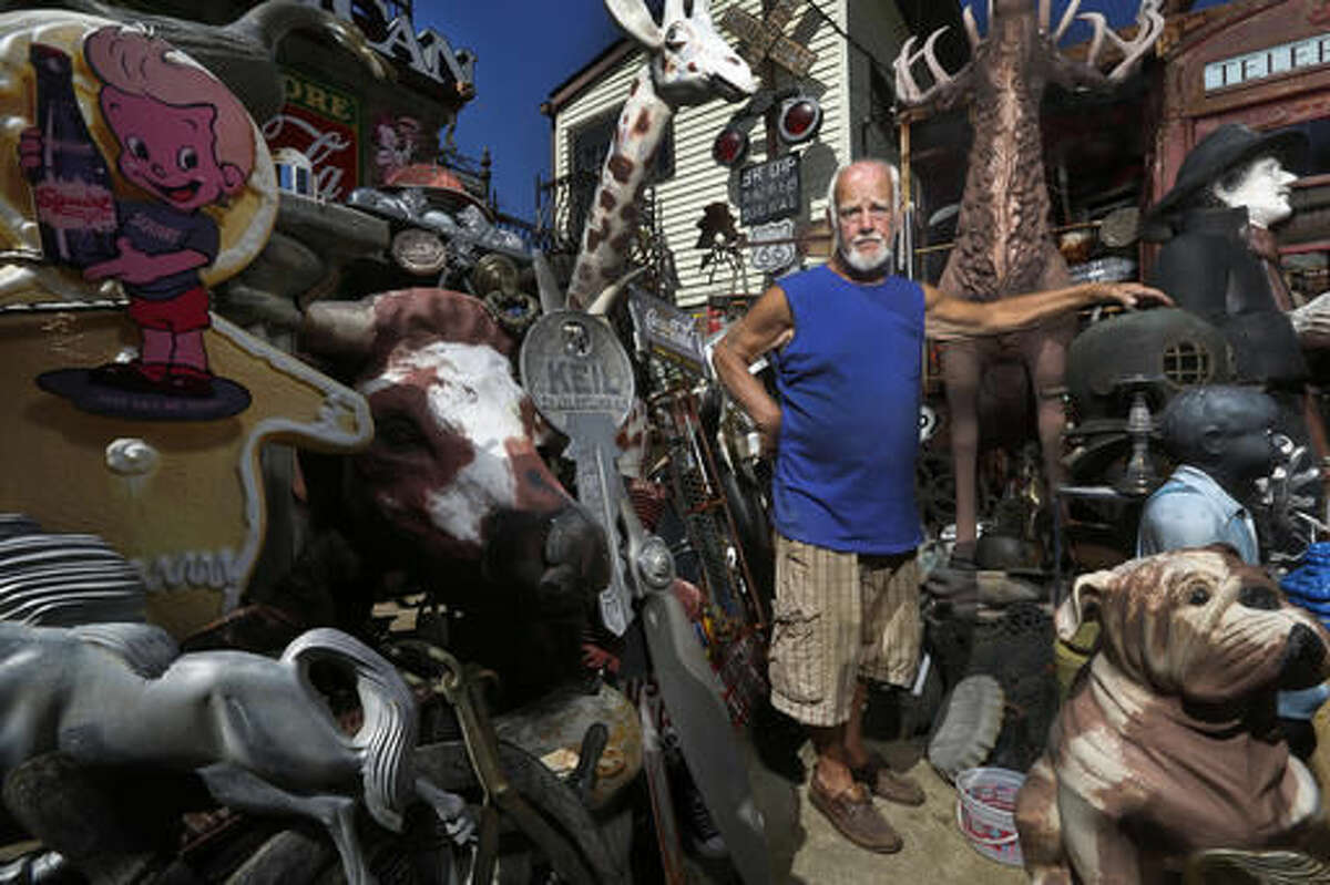 Jerry Lotz stands with some of the antiques at his home in Louisville, Ky., on Sept. 12, 2016. Lotz has been collecting unique items for over five decades. (Pat McDonogh/The Courier-Journal via AP)