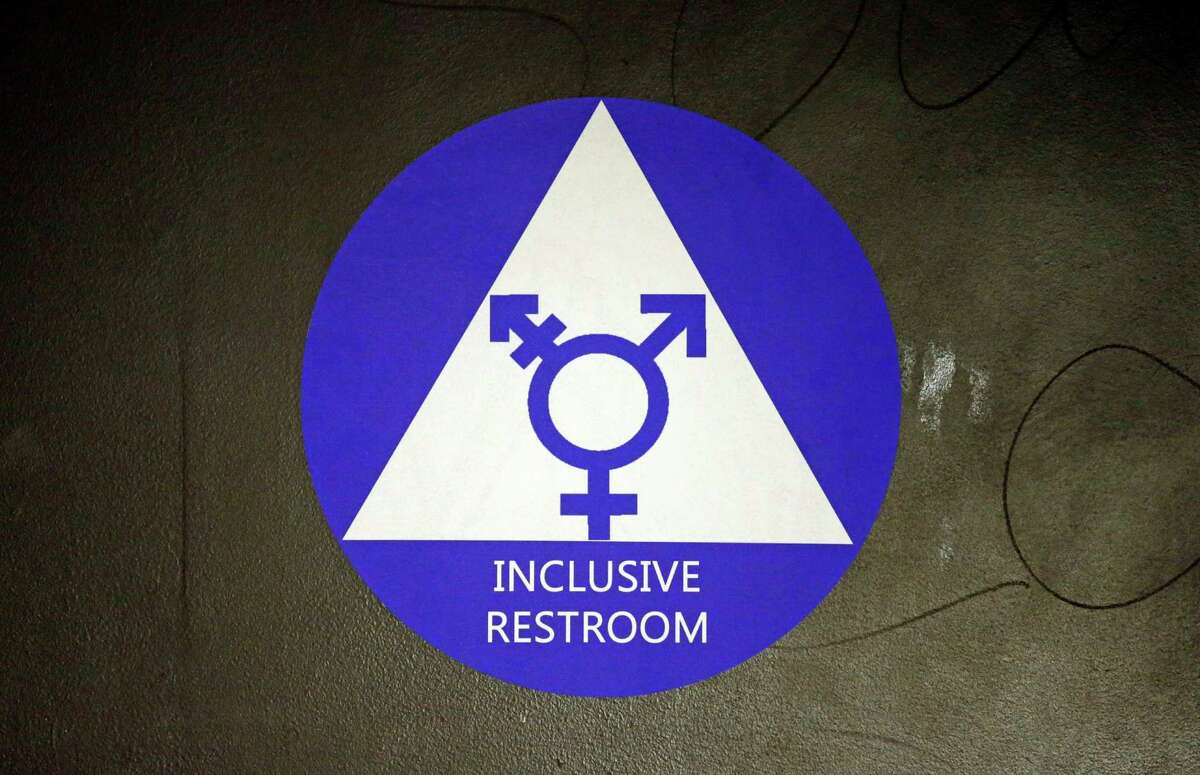 FILE - In this May 17, 2016, file photo, a new sticker designates a gender neutral bathroom at Nathan Hale high school in Seattle. A federal judge in Texas is blocking for now the Obama administration's directive to U.S. public schools that transgender students must be allowed to use the bathrooms and locker rooms consistent with their chosen gender identity. (AP Photo/Elaine Thompson, File)