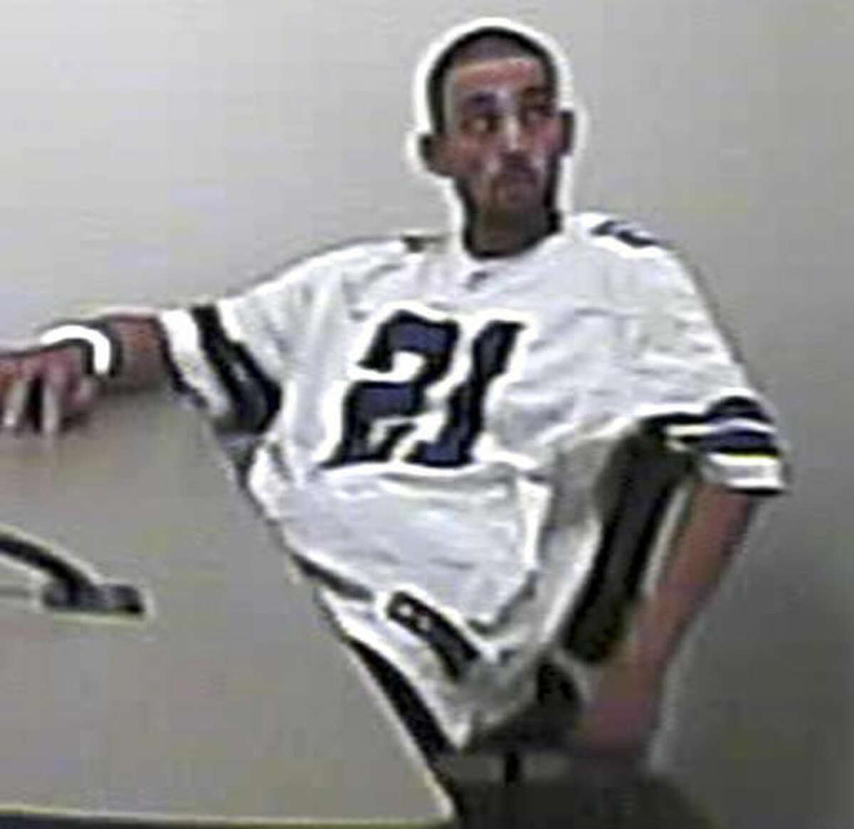 This Friday, Sept. 2, 2016 photo provided by the North Las Vegas Police Department shows Alonso Perez handcuffed to a table in a police interview room where he was awaiting questioning in a homicide investigation. On Tuesday, Sept. 6, 2016, authorities said he remained on the loose, four days after he broke his metal handcuffs and escaped from custody. (North Las Vegas Police Department via AP)