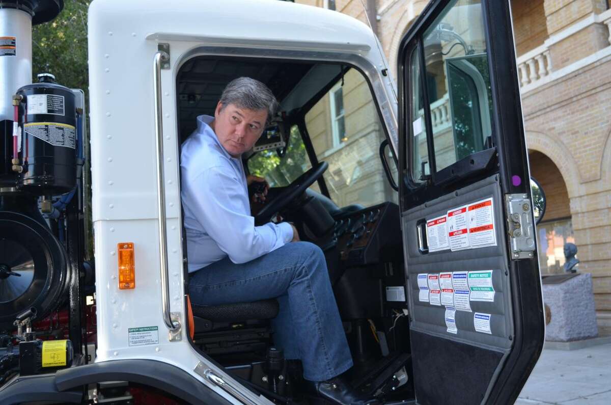 Webb County Commissioner John Galo tests the equipment of one of the three new trash trucks recently added to the fleet at the Road and Bridge Department. The trucks were displayed at the Webb County Courthouse Friday morning and will be used to service the growing needs of the residents of Webb County. (Courtesy photo)