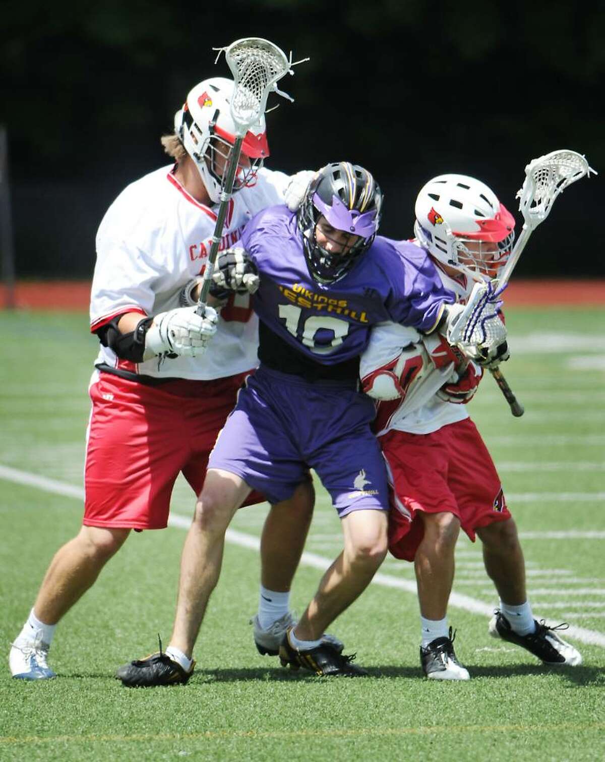 Westhill High School's Tom McCartney is pressurd by Greenwich High School's Todd Stafford and Jake Stein in boys lacrosse action in Greenwich, Conn. on Saturday May 15, 2010.