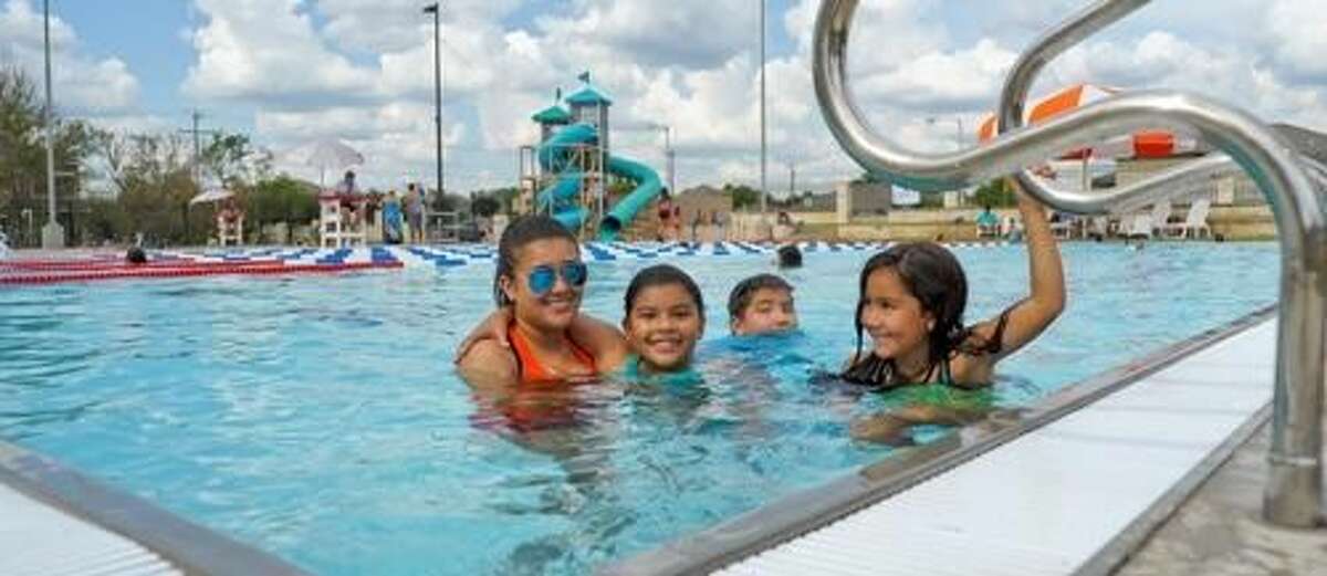 Jeanette Hernandez, Bianca Puente, Christopher Rodriguez and Kimberly Rodriguez smile as they tread water at the Rev. Deacon Leonel and Irma San Miguel Swimming Pool Complex on Sunday afternoon. Photo by Danny Zaragoza