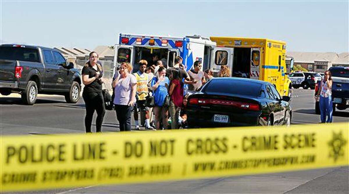 Emergency personnel stand by near Rainbow Blvd. in Las Vegas, Sunday, Sept. 25, 2016, after a shooting inside a Starbucks at a southwest valley strip mall. (Chitose Suzuki/Las Vegas Review-Journal via AP)