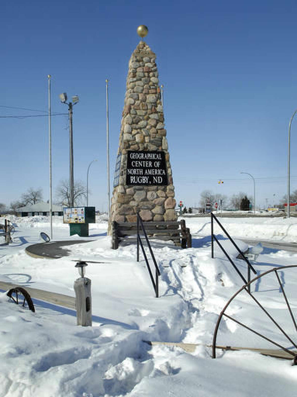 FILE - In this March 1, 2010 file photo, a twenty one foot tall obelisk marks the spot the town of Rugby says is the Geographic center of North America, in Rugby N.D. The town built the obelisk in 1932 and has trademarked the title. Hanson's Bar in Robinson is now touting its continental bull's-eye status after snatching the title from the nearby city of Rugby that allowed its trademark to lapse. (AP Photo/Will Kincaid, File)