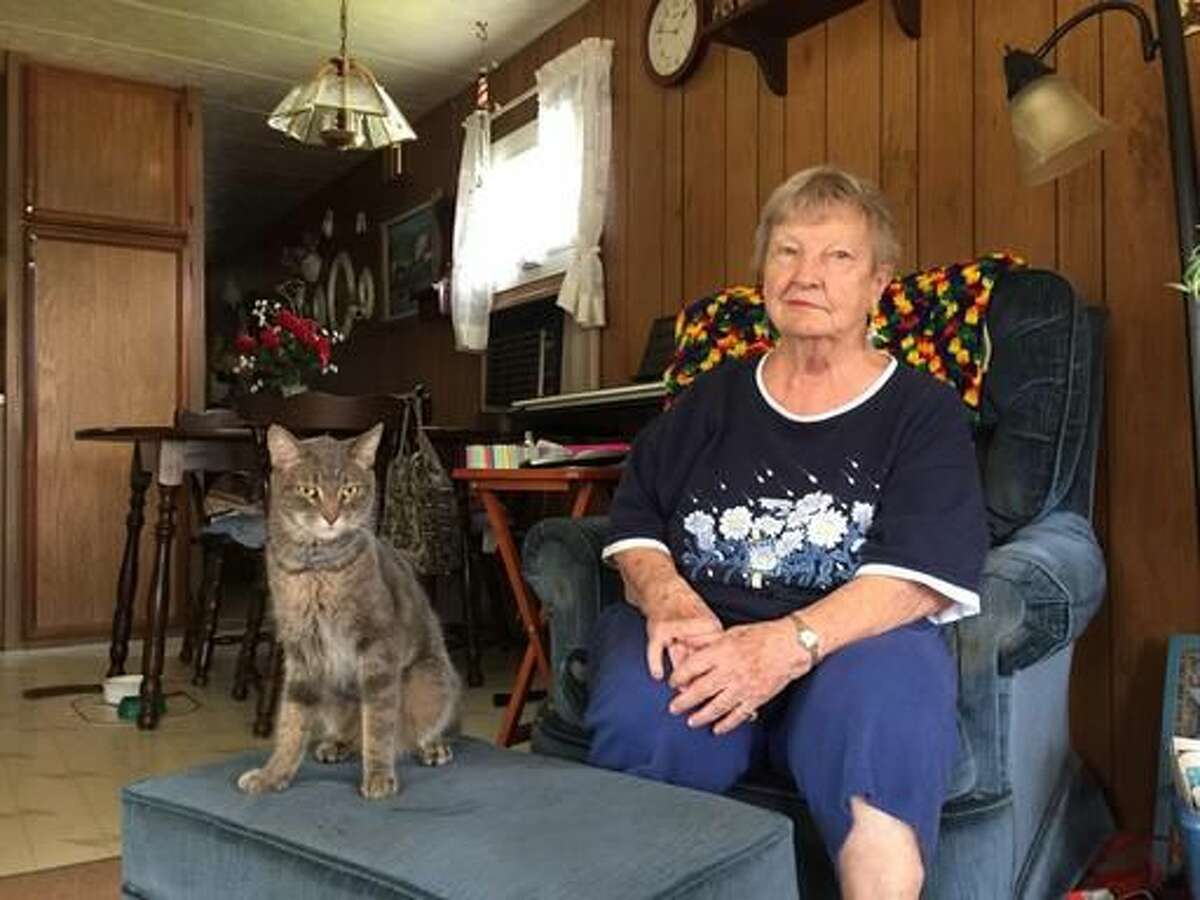 Jeannette Haskins, of Egg Harbor Township, and her cat, Mokey, were reunited after being separated five weeks ago when Haskins got lost in the woods at Fort Dix, NJ. (Claire Lowe/The Press of Atlantic City via AP)