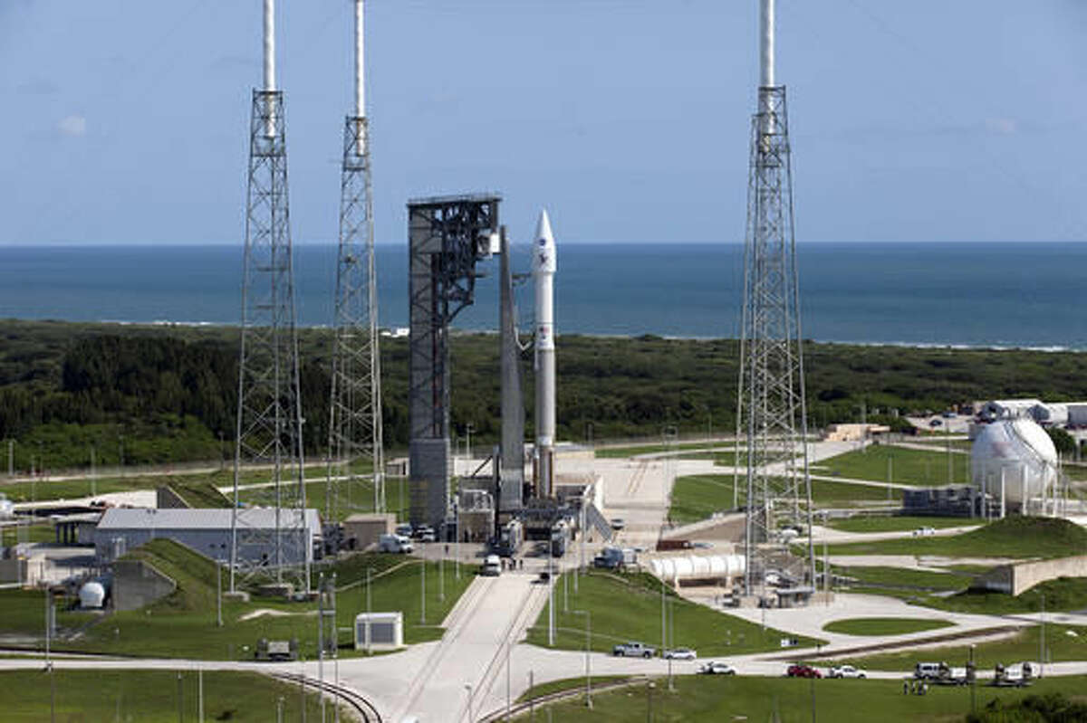 In this Wednesday, Sept. 7, 2016 photo made available by NASA, a United Launch Alliance Atlas V rocket, carrying NASA's OSIRIS-REx spacecraft, is brought to its launchpad at Cape Canaveral Air Force Station in Florida. The mission, scheduled to launch on Thursday, Sept. 8, is the first U.S. attempt to reach an asteroid return a sample to Earth for study. (Kim Shiflett/NASA via AP)