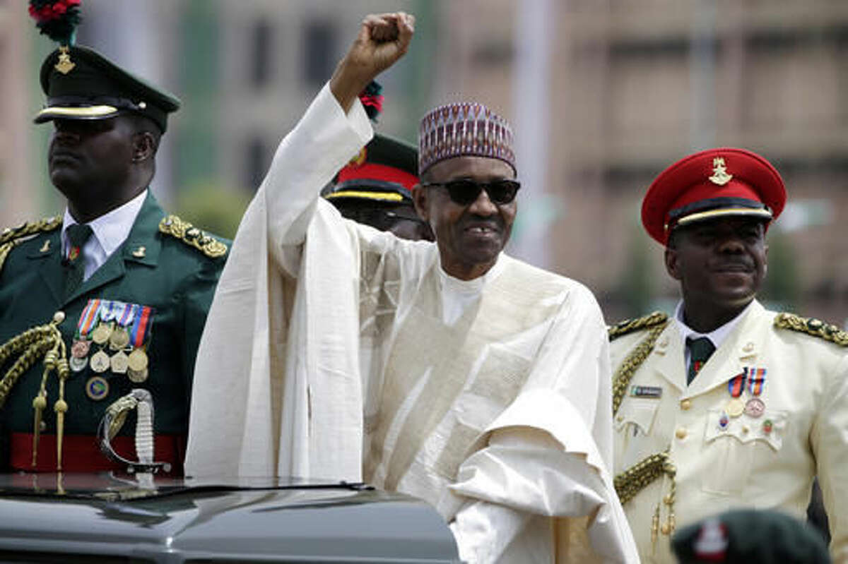 FILE - In this May 29, 2015 file photo, Nigeria President Muhammadu Buhari salutes his supporters during his inauguration in Abuja, Nigeria. Nigeria's President Muhammadu Buhari has apologized for plagiarizing President Barack Obama's 2008 victory speech and says he will punish those responsible. Adeola Akinremi in her Friday, Sept. 16, 2016 column for ThisDay newspaper denounced "the moral problem of plagiarism on a day Mr. President launched a campaign to demand honesty and integrity." (AP Photo/Sunday Alamba, File)