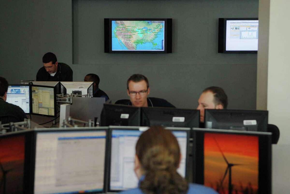 GE workers in the renewable energy remote operations center at the Renewable Energy Global Headquarters at GE in Schenectady, NY monitor wind turbine sites across the U.S. on Monday, Feb. 1, 2010. (Paul Buckowski / Times Union)