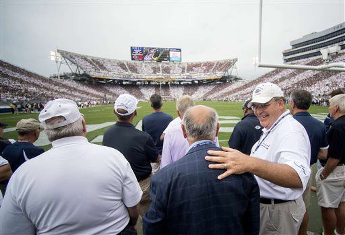 Members of the 1966 football team, who were the first to be led by Penn State head football coach Joe Paterno watch during an NCAA college football game between Penn State and Temple, Saturday, Sept. 17, 2016, at State College, Pa. Penn State defeated Temple 34-27, and celebrated the 50th anniversary of former head coach Joe Paterno's first game by honoring members of the 1966 football team and showing video tributes on the scoreboard. (Abby Drey/Centre Daily Times via AP)