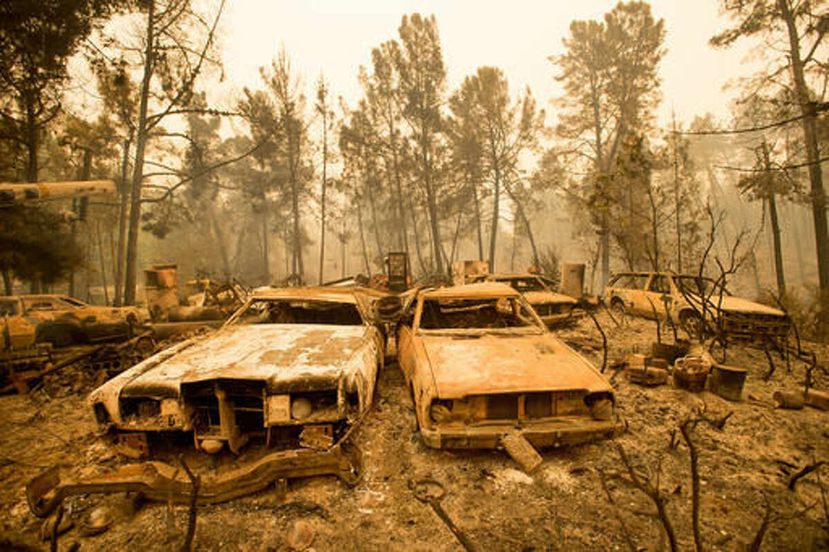 Vintage cars line a property after the Loma fire burned through Loma Chiquita Road near Morgan Hill, Calif., on Wednesday, Sept. 28, 2016. A heat wave stifling drought-stricken California has worsened a wildfire that burned some buildings and forced people from their homes. (AP Photo/Noah Berger)