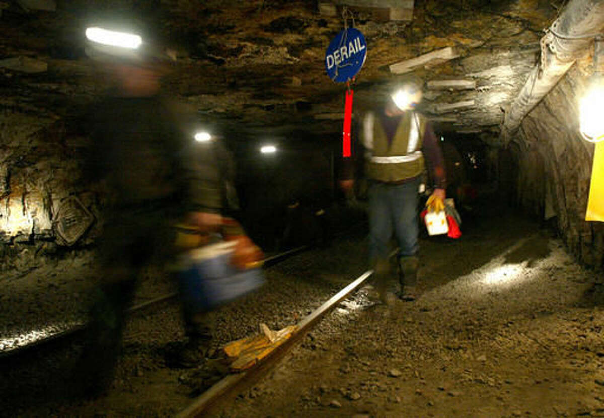FILE - In this March 10, 2006 file photo, Ohio coal miners head into the mine for a shift inside the Hopedale Mine near Cadiz, Ohio. An election-year bill that would protect health-care and pension benefits for more than 100,000 retired coal miners is dividing coal-state Republicans. Thousands of miners are expected to gather at the Capitol to push for the measure, which they describe as life-saving and fulfilling a promise the government made in 1946. (AP Photo/Joe Maiorana, File)