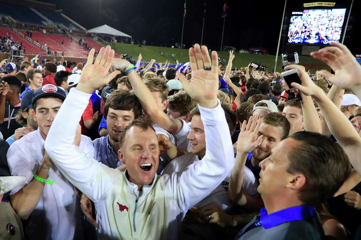 DALLAS, TX - OCTOBER 22: Head coach Chad Morris of the Southern Methodist Mustangs celebrates with fans after the Southern Methodist Mustangs beat the Houston Cougars 38-16 at Gerald J. Ford Stadium on October 22, 2016 in Dallas, Texas.