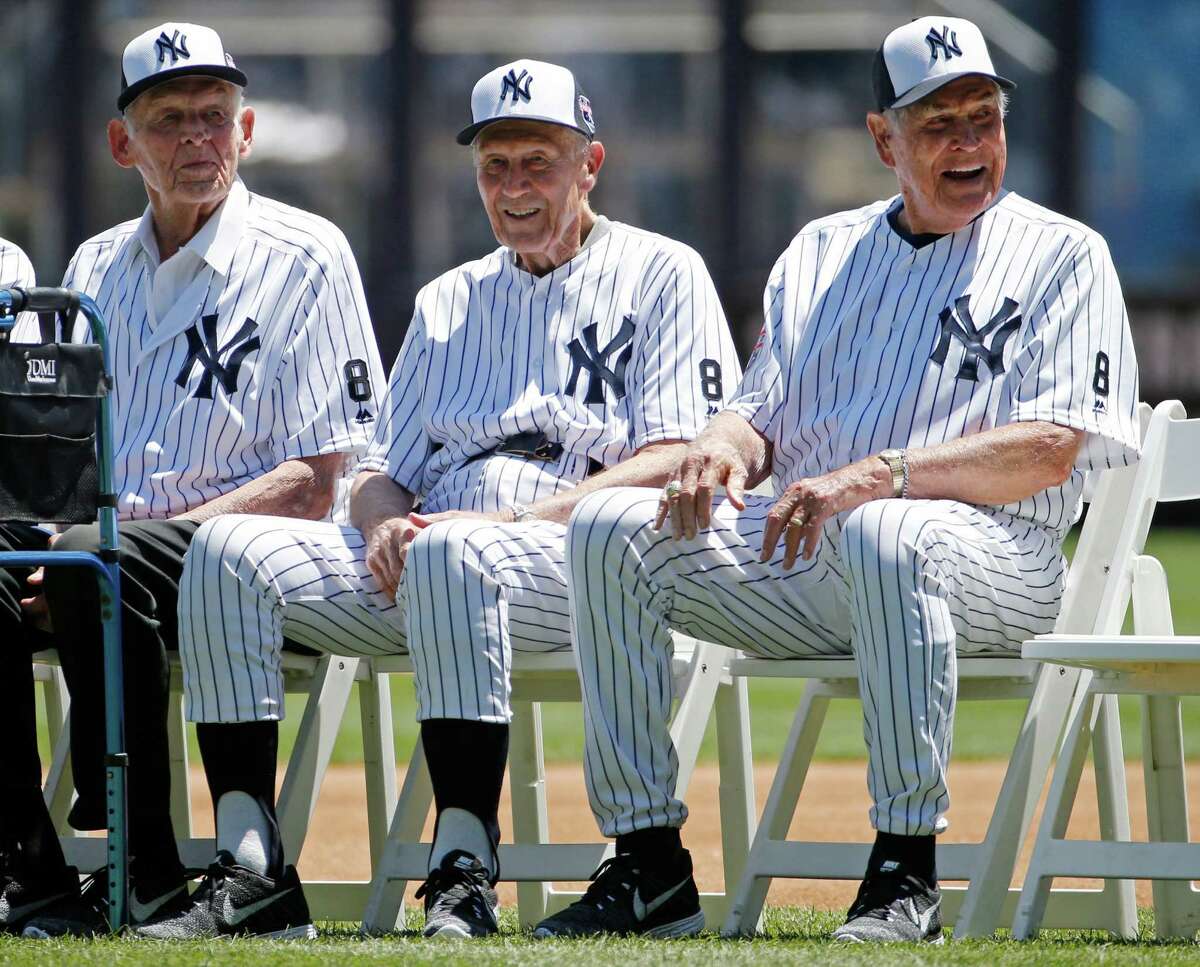 From left, former Yankees pitcher Don Larsen, the only person in Major League Baseball to pitch a perfect game in the World Series, Dr. Bobby Brown, and Eddie Robinson, the oldest living Yankee, sit beside each other before the Yankees annual Old Timers Day baseball game, Sunday, June 12, 2016, in New York. (AP Photo/Kathy Willens)