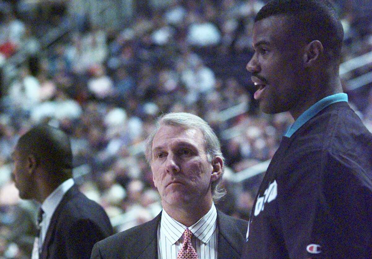 Spurs coach Gregg Popovich and Spurs center David Robinson confer before Popovich’s first game as head coach on Dec. 10, 1996 against the Phoenix Suns in Phoenix. Popovich was also general manager at the time and had just fired coach Bob Hill to take over the team, a move that angered many fans since Robinson returned to the lineup that same day after missing the first 18 games. The Spurs went on to have their worst season in franchise history with a 20-62 record.