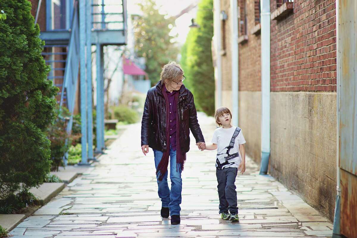 Bass guitarist Tom Petersson, a founding member of Cheap Trick, walks with his son, Liam. Cheap Trick performs at the Ridgefield Playhouse on Tuesday, Nov. 1.