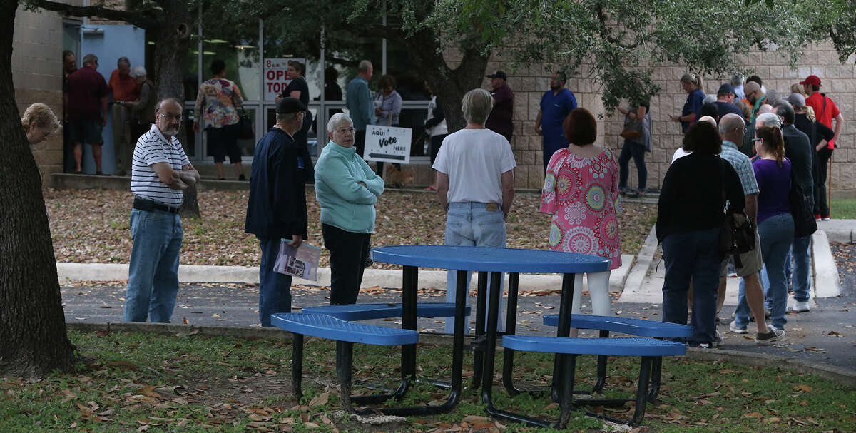 Voters line up Monday October 24, 2016 at the Brook Hollow Branch of the San Antonio Public Library for the first day of early balloting in the November 8 election.