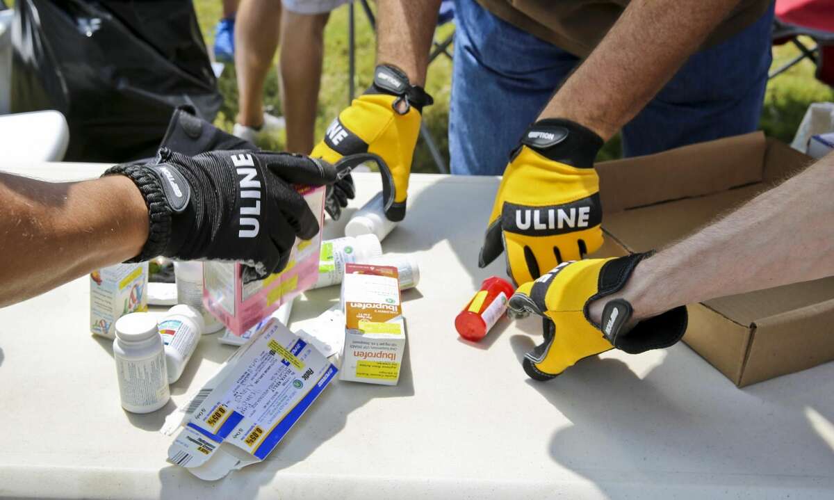 In this Saturday, April 26, 2014 file photo, U.S. Drug Enforcement Administration agents separate prescription medication before sealing them away in boxes for proper disposal during the National Prescription Drug Take-Back Day. (Photo by Victor Strife/Laredo Morning Times)