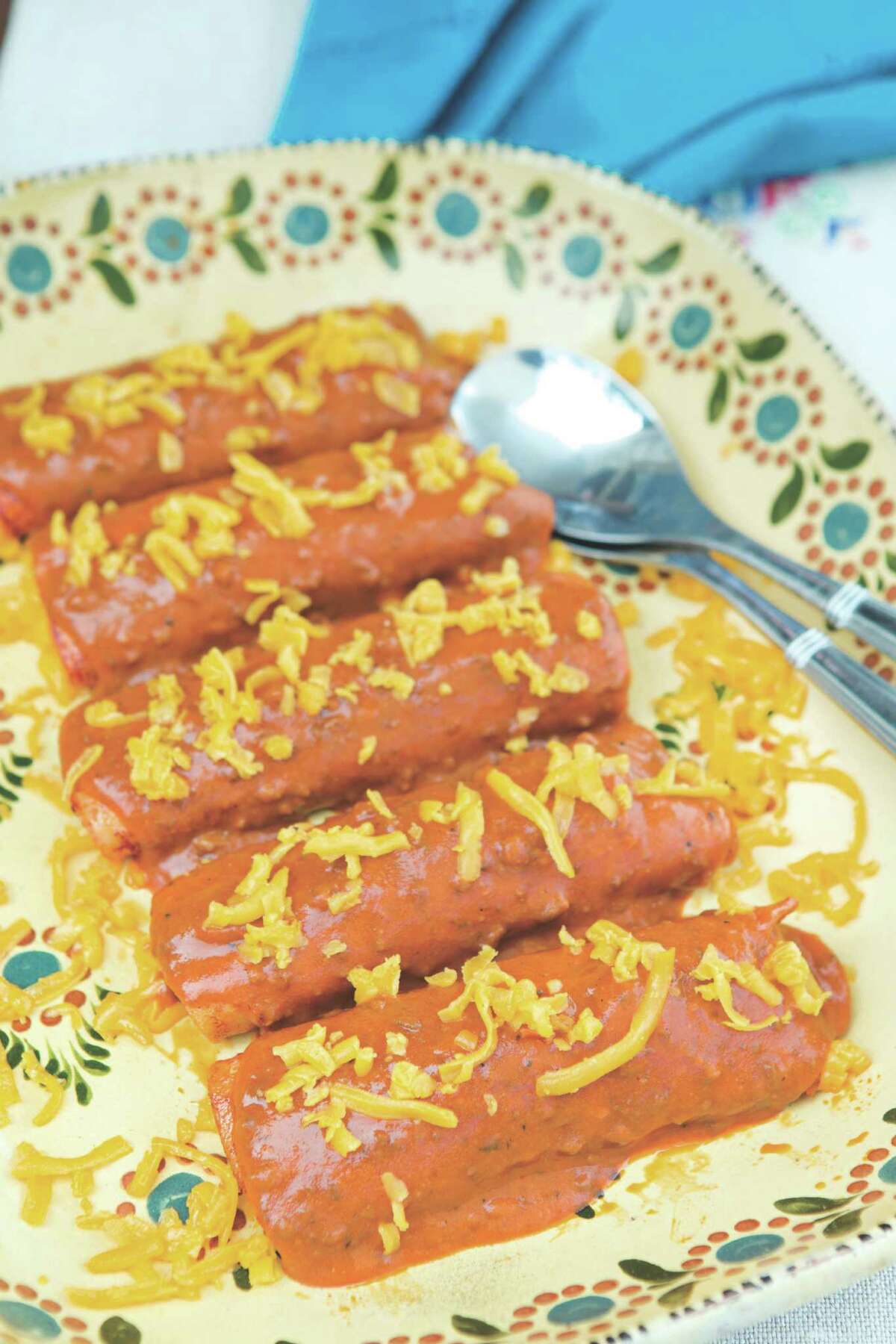 Cheese Enchiladas with Chili Gravy are featured in "The Enchilada Queen Cookbook" by Sylvia Casares. Recipe, page D2