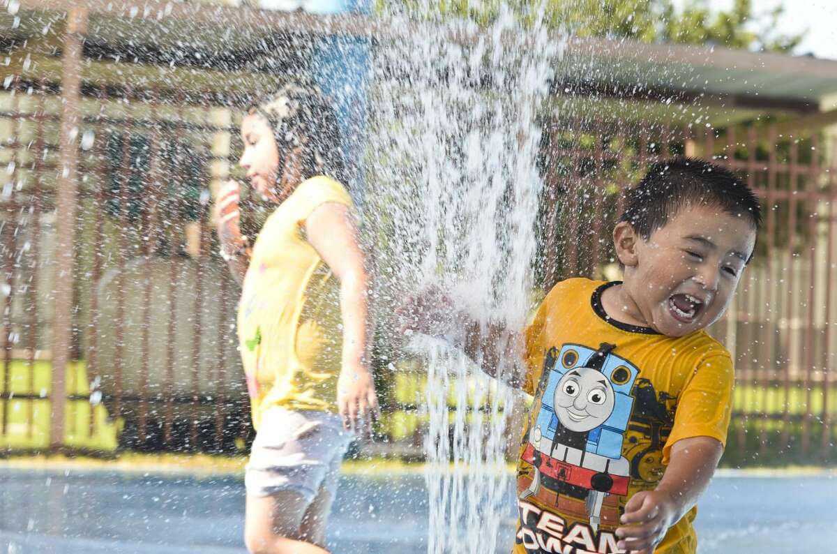Antonio Gabriel laughs as he approaches the stream of water shooting from the ground at the Farias Water Park in this June 18, 2013 file photo. Click through the gallery to see the top 21 water parks in Texas.