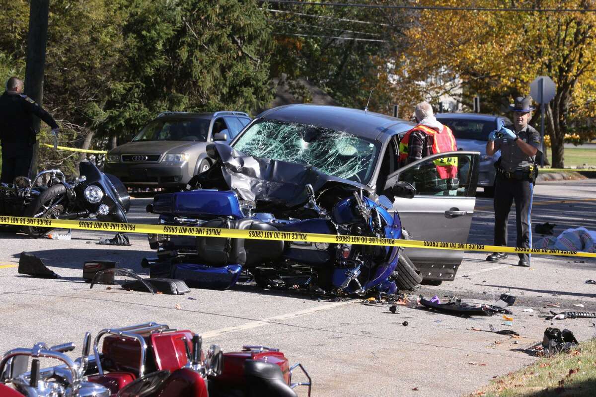 LITCHFIELD, CT - 23 October 2016 - 102316JM02 - Litchfield, Conn. Volunteer Ambulance emergency medical technician Mike Castelli and a Connecticut state trooper work at the scene of an accident involving a car and several motorcycles on Route 63 in Litchfield, Conn on Sunday October 23rd 2016. (AP Photo/The Republican-American, John McKenna)