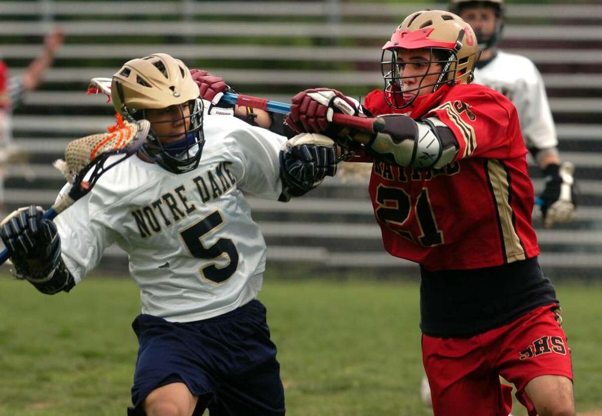 Notre Dame of Fairfield No. 5 Jose Rivera moves the ball against Stratford No. 21 Vinny Valente during high school lacrosse action Monday, May 17th, 2010, in Fairfield.