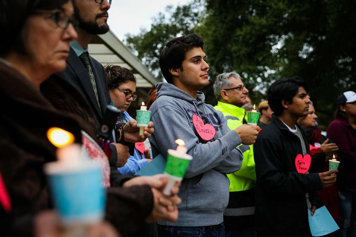 Pierre Prevot (center) holds a candle while listening to a prayer vigil, which was held to honor those impacted by the housing crisis, ahead of the Concord City Council's Housing and Economic Development Committee meeting, in Concord, California, on Monday, Oct. 24, 2016.