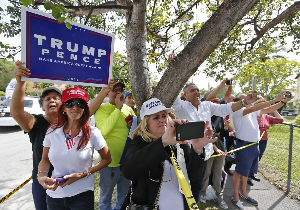 Trump supporters wave to Donald Trump after the presidential nominee leaves the Bay of Pigs museum after addressing the Brigade 2506, veterans of the Cuban battle on Tuesday, October 25, 2016. (Al Diaz/Miami Herald via AP)