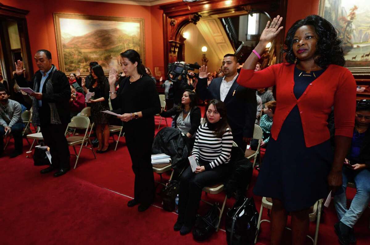 U.S. Citizenship and Immigration Services (USCIS) presents 20 candidates for naturalization to the U.S. District Court for the District of Connecticut, including Heather Brown of Jamaica, right, on Tuesday, October 25, 2016, at Lockwood-Mathews Mansion Museum in Norwalk, Conn. The Honorable Stefan R. Underhill, United States District Judge, District of Connecticut, administered the Oath of Allegiance to America?’s newest citizens during the naturalization ceremony.