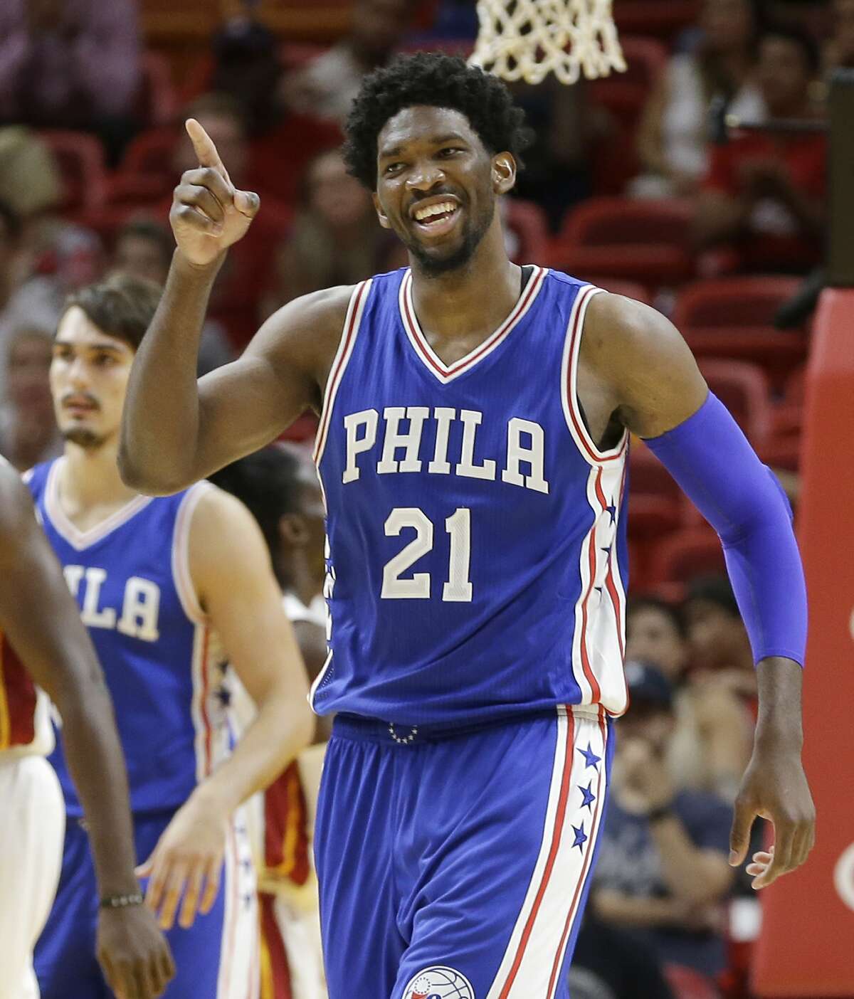 FILE - In this Oct. 21, 2016, file photo, Philadelphia 76ers center Joel Embiid celebrates after scoring against the Miami Heat during the second half of an NBA preseason basketball game, in Miami. Embiid has the joyous personality of a kid himself, and social media posts that include him crushing on Rihanna or teasing an Australian-born teammate that he'll get deported if Donald Trump is elected president of the United States made him beloved already in Philly. (AP Photo/Alan Diaz, File)
