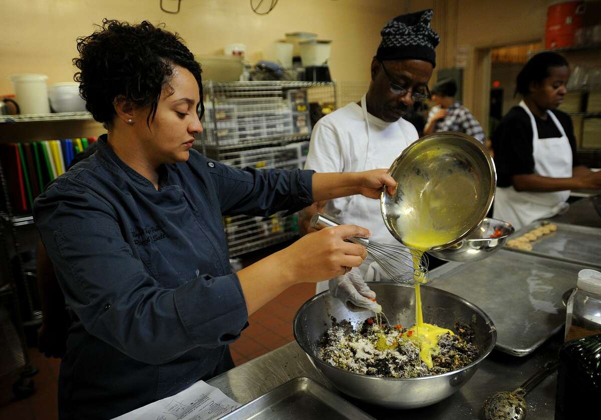 Chef Raquel Rivera-Pablo, left, combines the ingredients for black bean burgers with cooking student Randy Jackson, both of Bridgeport, during an intensive twelve week cooking course in the commercial kitchen at the United Congregational Church at 877 Park Avenue in Bridgeport, Conn. on Tuesday, October 25, 2016.