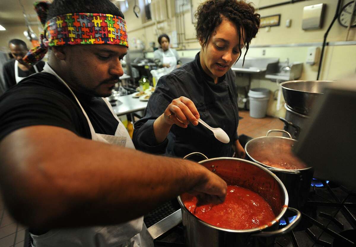 Cooking student St. V. Padilla, left, makes tomato soup under the guidance of instructor Raquel Rivera-Pablo, both of Bridgeport, during an intensive twelve week cooking course in the commercial kitchen at the United Congregational Church at 877 Park Avenue in Bridgeport, Conn. on Tuesday, October 25, 2016.