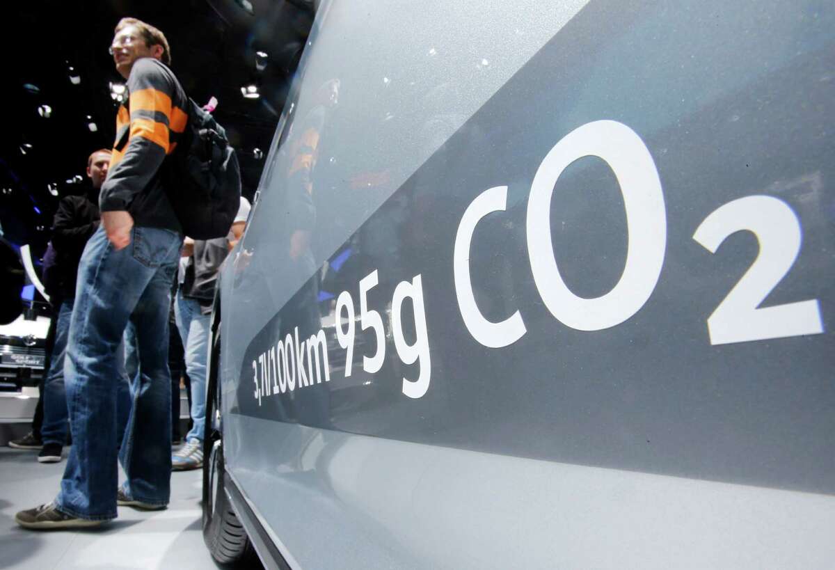 FILE - In this Sept. 22, 2015, file photo, the amount of carbon dioxide emissions is written on a Volkswagen Passat Diesel at the Frankfurt Car Show in Frankfurt, Germany. A federal judge in San Francisco is facing a deadline on whether to approve a nearly $15 billion deal over Volkswagen's emissions cheating scandal that gives most affected car owners the option of having the company buy back their vehicles. U.S. District Judge Charles Breyer said at a hearing last week that he was strongly inclined to give the deal final approval and would issue a ruling by Tuesday, Oct. 25, 2016. (AP Photo/Michael Probst, File)