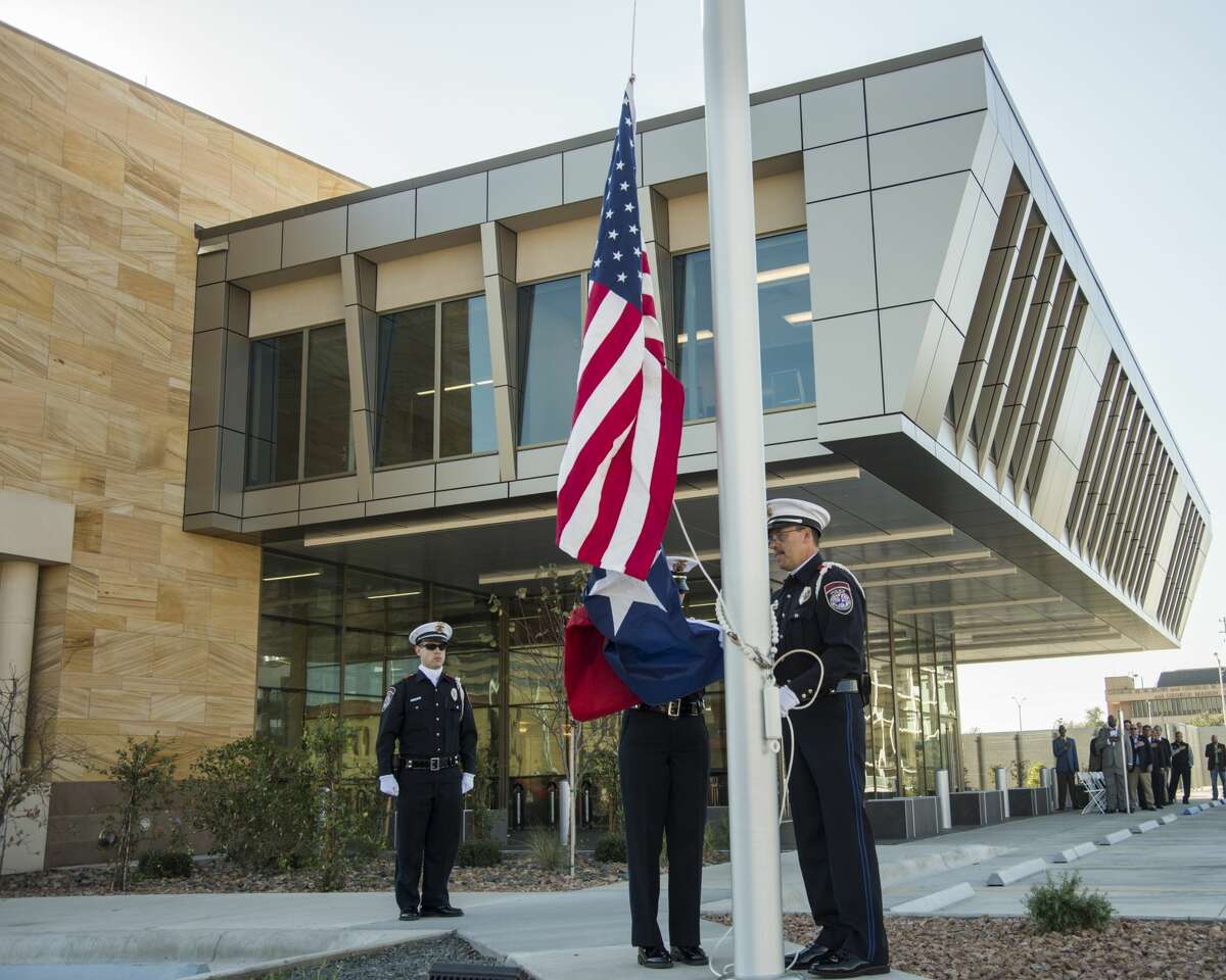 Members of Midland Police Honor Guard raise the flag Wednesday 10-26-16 to help open the new Municipal Courthouse. Tim Fischer/Reporter-Telegram