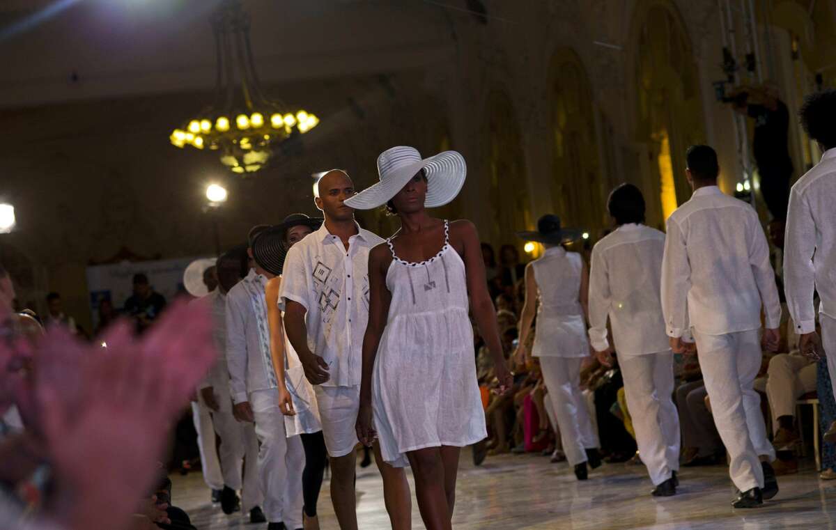 In this Oct. 14, 2016 photo, models present the collection of Cuban fashion designer Analu during Havana Fashion Week at the Alicia Alonso Grand Theater in Havana, Cuba. CubaÂ?’s designers are hoping that their lightweight blouses and fringed swimsuits will become popular items for visitors to take home. (AP Photo/Ramon Espinosa)