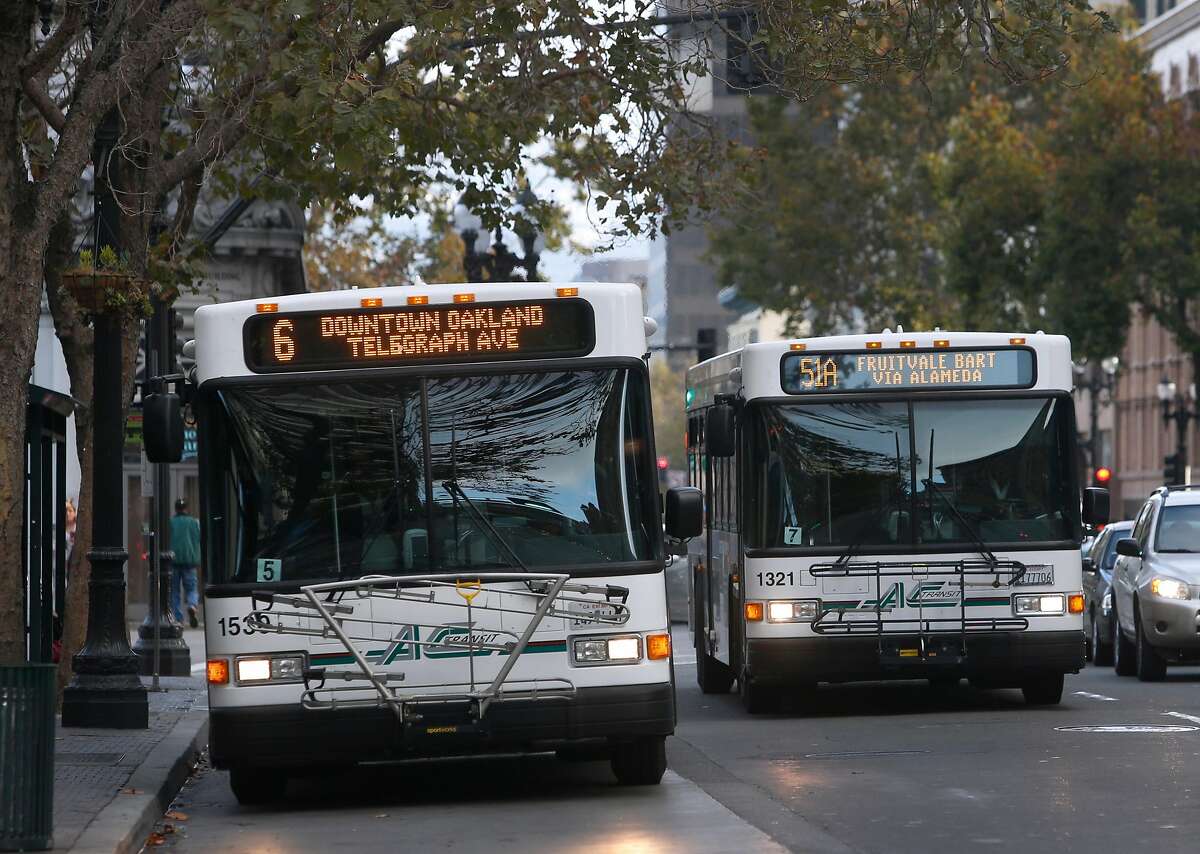 AC Transit buses drive on Broadway near City Hall in Oakland, Calif. on Wednesday, Oct. 26, 2016. Measure C1 on the Alameda County ballot is one of several tax proposals that Bay Area voters will consider to support public transportation.