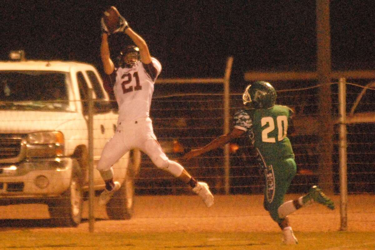 Abernathy receiver Kole Carlisle, 21, makes a leaping catch against Floydada as the Whirlwinds' Abraham Perez, 20, defends during a District 2-2A football game last week. Abernathy will take on New Deal in a battle of district unbeatens in Abernathy Friday.