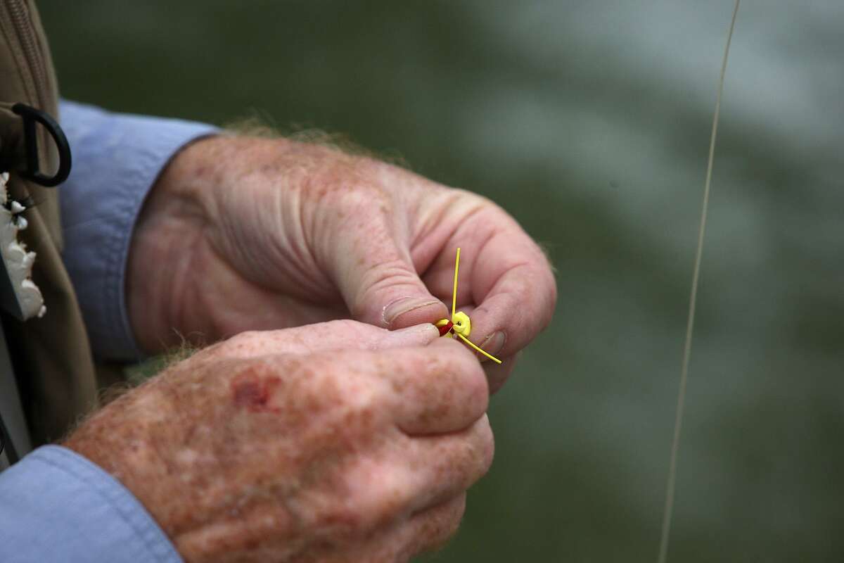 Ted Warren changes flies during the Reel Recovery Texas Fly Fishing Retreat for Men with Cancer at Joshua Creek north of Boerne on Nov. 7, 2011. The Reel Recovery mission is to help men deal with the recovery process and help in their healing through fly-fishing.