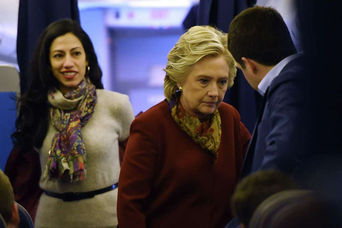 Democratic presidential nominee Hillary Clinton chats with her staff, including aide Huma Abedin (L), onboard her plane in White Plains, New York. The emails about the Clinton Foundation released by WikiLeaks show an intense focus on image, and in turn, a glaring absence of morality. The chatter is often about how to insulate Hillary Clinton from the appearance of a conflict, not about making ethical decisions that avoid such conflicts.