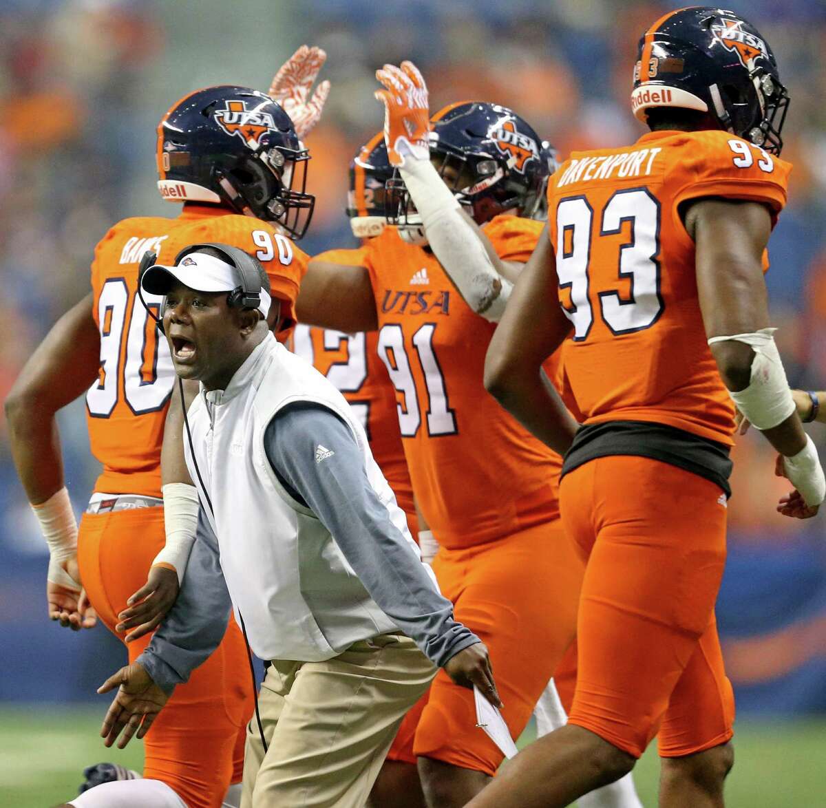 UTSA Roadrunners coach Frank Wilson greets players as they copme off the field after a play against the UTEP Miners on Oct. 22, 2016 at the Alamodome.