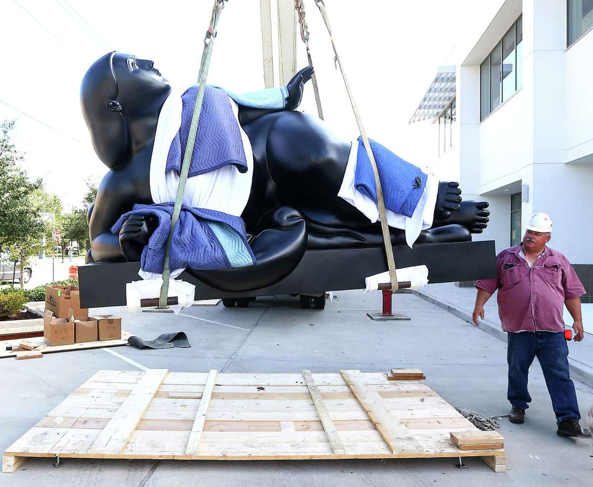 The two-ton Fernando Botero sculpture "Woman with Fruit" was hoisted into place at Art of the World Gallery on Monday.