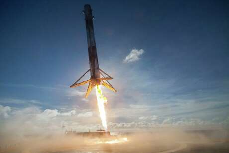 FILE - In this May 27, 2016 photo made available by SpaceX, their Falcon rocket booster lands on a platform in the Atlantic Ocean after launching a satellite into orbit. Its name is a nod to the Millennium Falcon piloted by Han Solo in the Star Wars movie series. It's powered by Merlin engines. (SpaceX via AP)