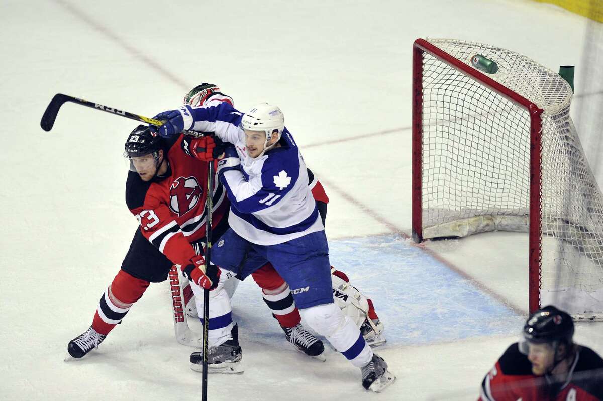 Vojtech Mozik of the Albany Devils, left, and Zach Hyman of the Toronto Marlies fight for position in front of the net during their American Hockey League quarterfinal playoff series game on Sunday, May 8, 2016, in Albany, N.Y. (Paul Buckowski / Times Union) ORG XMIT: MER2016102715314314