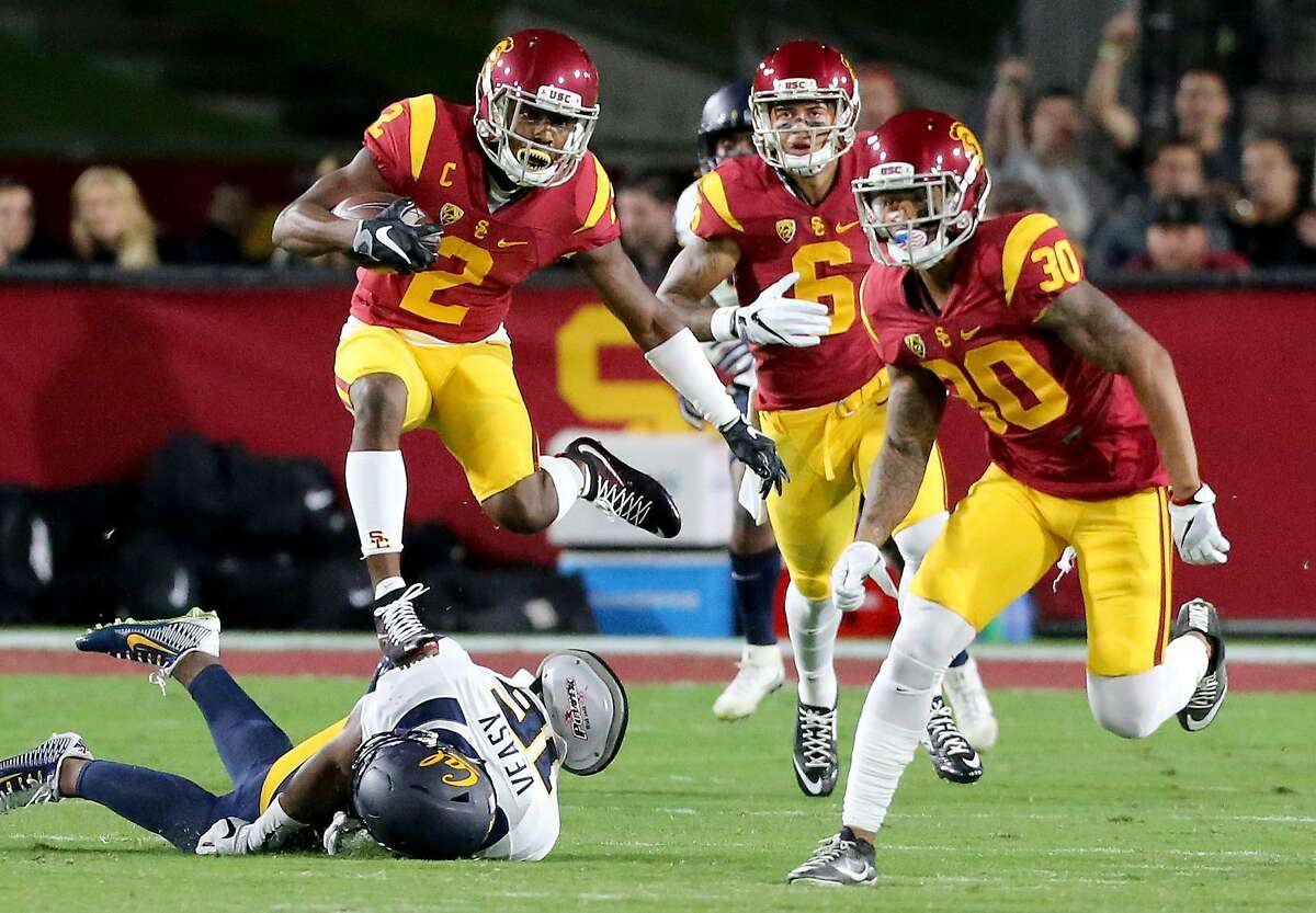 USC defensive back Adoree Jackson hurdles over Cal cornerback Chibuzo Nwokocha on a punt return in the first quarter on Thursday, Oct. 27, 2016, at the Los Angeles Memorial Coliseum. (Luis Sinco/Los Angeles Times/TNS)