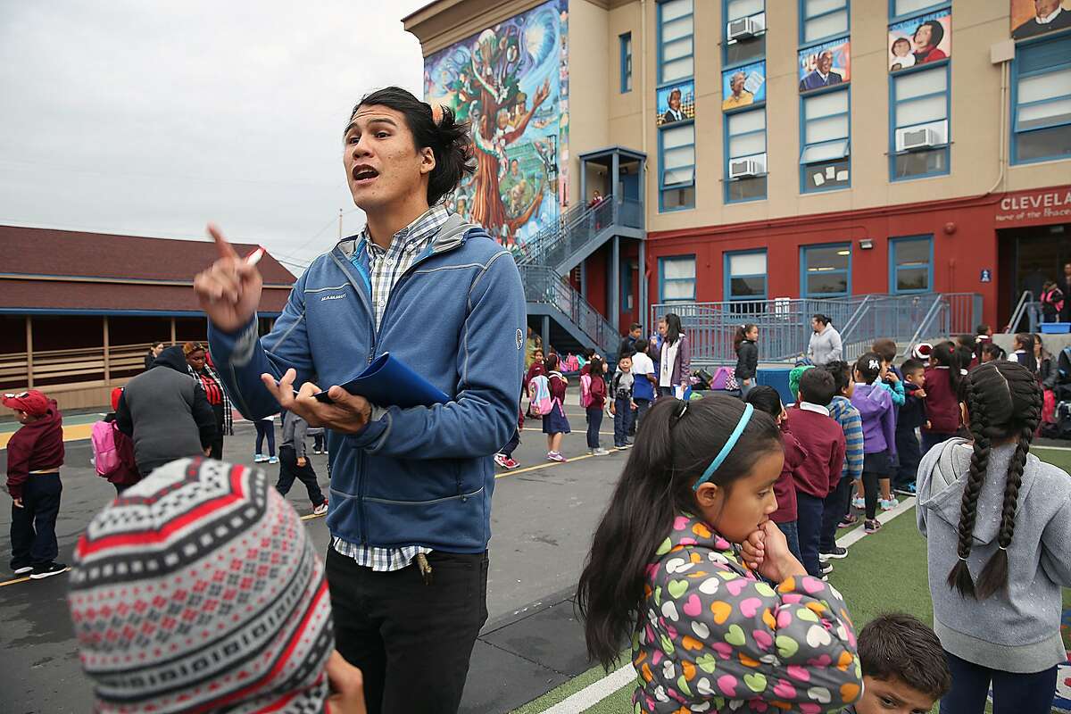 Cleveland Elelmentary school teacher Fernando Che greets his third graders during morning assembly on Thursday, October 27, 2016, in San Francisco, Calif.