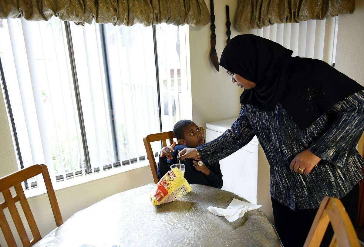 Nahla Taha talks with her son Amin Abbas, 7, after her returned home from afternoon prayers at the nearby mosque, in their apartment at the affordable housing community of Ashland Village Apartments, run by Emerald Development & Economic Network, in San Leandro, CA Friday, October 28, 2016.