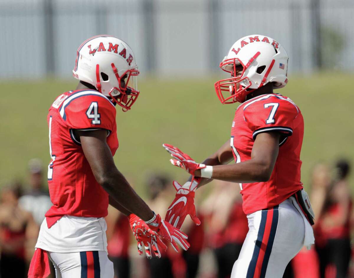 Lamar Texans wide receiver Al'vonte Woodard (4) and Lamar Texans wide receiver Ty Holden (7) celebrate after a touchdown during the high school football game between the Lamar Texans and the Bellaire Cardinals at Delmar Stadium in Houston, TX on Saturday, October 29, 2016. The Texans lead the Cardinals 41-10 at halftime.