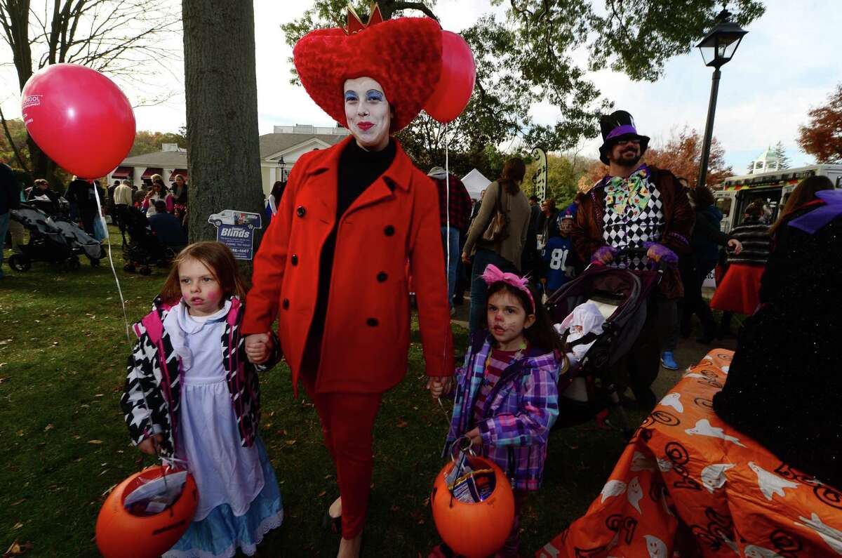 Nicole and Dan Grossman and their daughters, Lilian, Regan and Philomina join The Wilton Chamber of Commerce annual trick-or-treating and pumpkin parade in Wilton Center Saturday, October 29, 2016, in Wilton, Conn..