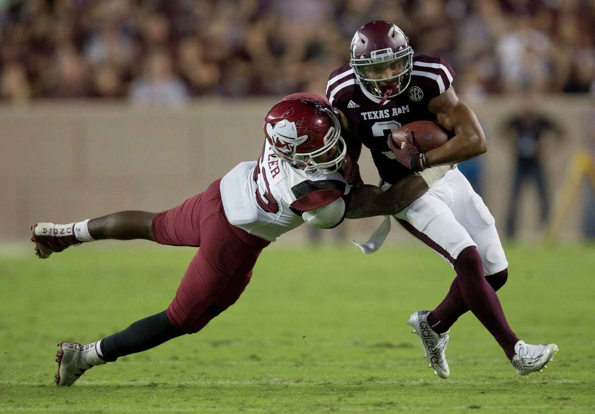 Texas A&M's Christian Kirk (3) fights off a tackle attempt by New Mexico State's Rodney Butler (53) during the first quarter of an NCAA college football game Saturday, Oct. 29, 2016, in College Station, Texas. Texas A&M won 52-10. (AP Photo/Sam Craft)